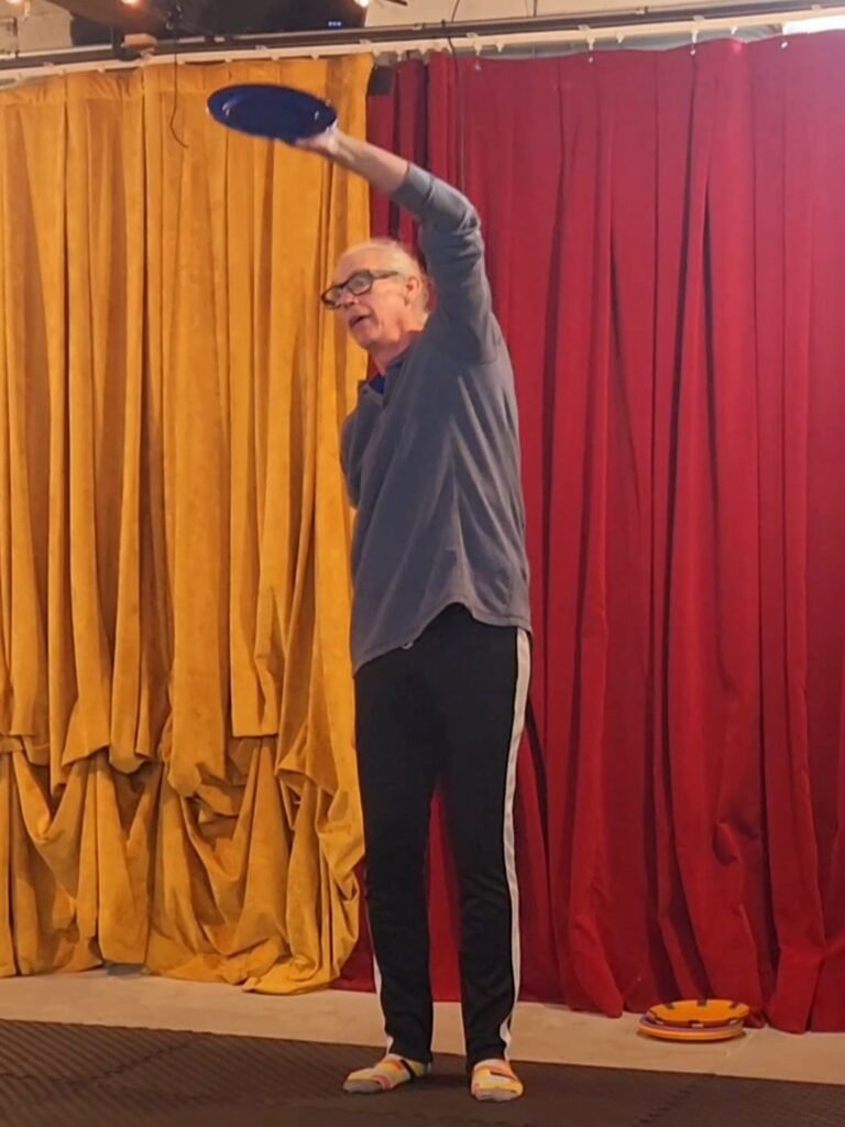 Michael Troutman teaching how to juggle a plate